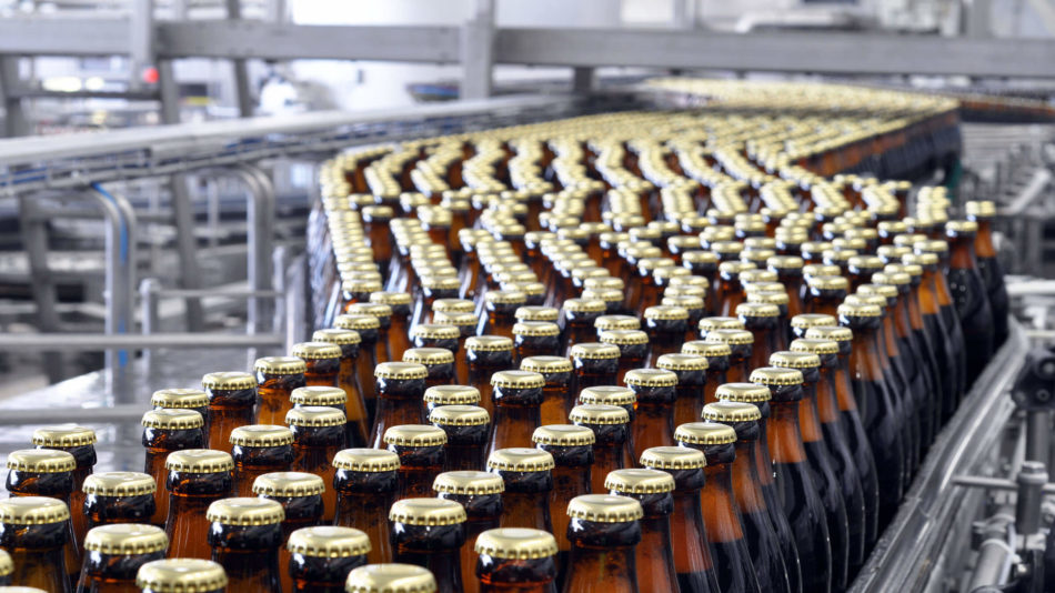 Case study image of beer bottles on a conveyor belt in a factory